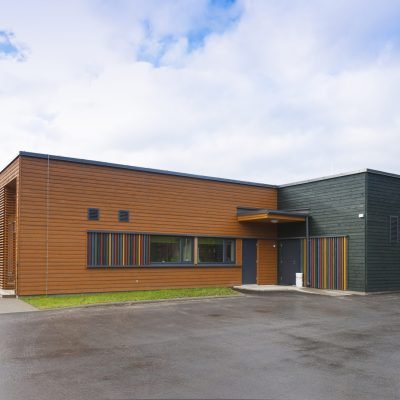 A modern building, a pre-school entrance and playground