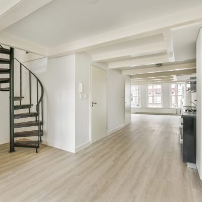 Bright hall with staircase access to the upper floor and a kitchen