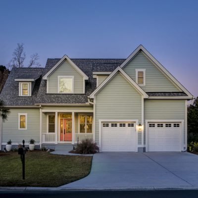 Front elevation of beautiful home lit up at twilight.