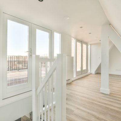 Interior design of an empty room with huge doors and windows