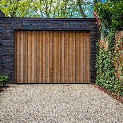 wide garage door and concrete driveway in front